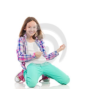 Smiling girl playing the air guitar