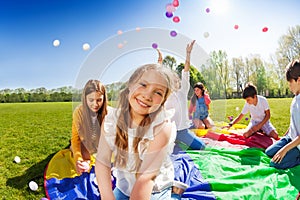 Smiling girl playing with friends in the park