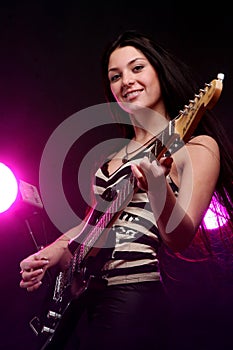 Smiling girl playing guitar