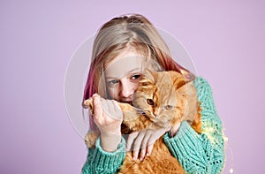 Smiling girl playing with her fluffy cat.