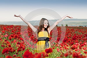 Smiling girl in the poppy field