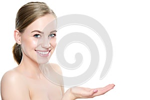 Smiling girl presenting point. Proposing product. Advertisement gesture