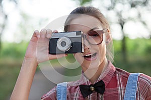 Smiling girl with retro camera
