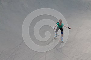Smiling girl roller skates on sport playground