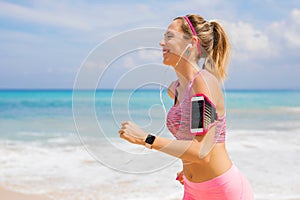 Smiling girl running and listening to music on earphones