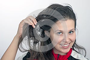 Smiling girl's face and hand tousling hair