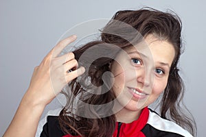 Smiling girl's face and hand tousling hair