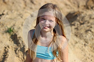 Smiling girl on sand