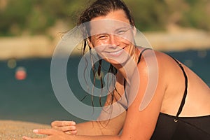 Smiling girl on sandy beach