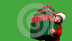 A smiling girl in a Santa hat holds a lot of gifts for Christmas and New Year 2023. Happy childhood. Sale and Black