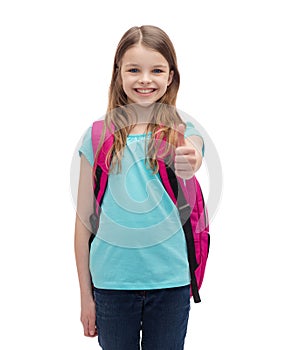 Smiling girl with school bag showing thumbs up