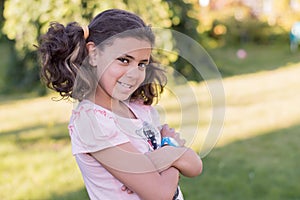 Smiling girl in shorts is in the garden