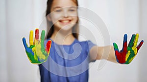 Smiling girl showing painted hands