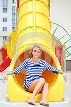 Smiling girl sitting at bottom of yellow photo