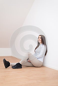 Smiling girl sitting on floor