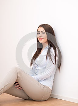 Smiling girl sitting on floor