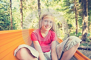 Smiling girl sitting in a hammock