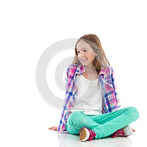 Smiling girl sitting with legs crossed