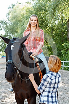 Smiling girl sitting in the saddle