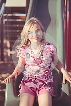 Smiling girl on slide