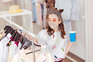 Smiling girl spending her leisure time in shopping mall