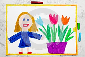 Smiling girl standing nex to flowerpot with tulips