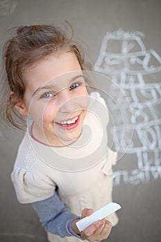 A smiling girl standing next to a