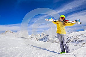 Smiling girl standing with ski.