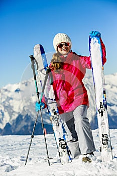 Smiling girl standing with ski.