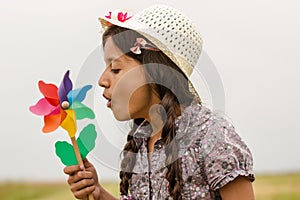 Smiling girl with pinwheel photo
