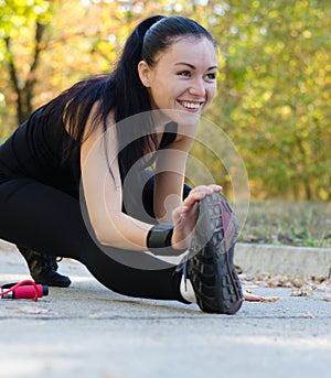 Smiling girl stretching in black leotard