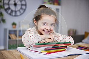 Smiling girl studying at home