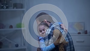 Smiling girl with teddy bear hugging father, returning back home, reunion