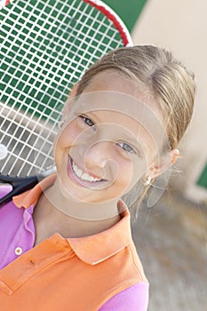 Smiling girl with tennis raket