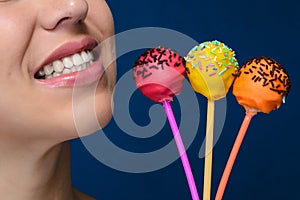 Smiling girl with three cakepops