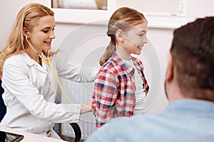 Smiling girl turning with back to her nurse