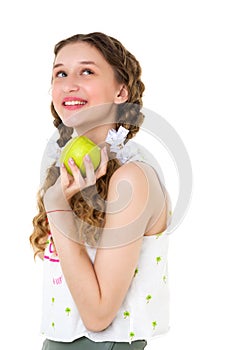 Smiling girl with two braids holding green apple