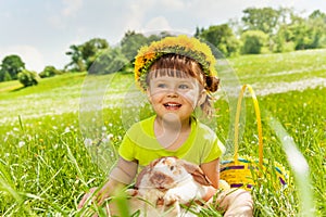 Smiling girl wearing flowers circlet and rabbit