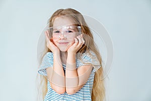 Smiling girl wears safety goggles.