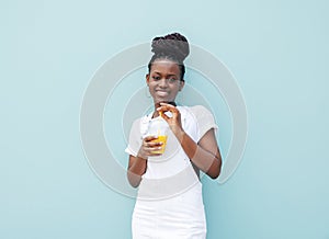 Smiling girl in white casual clothes leaning blue wall