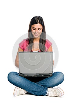 Smiling girl working on laptop