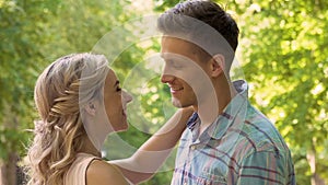 Smiling girlfriend hugging boyfriend in park, romantic date outside, tenderness