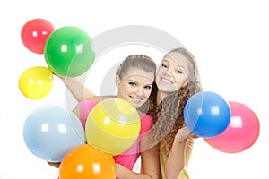 Smiling girls with balloons over white