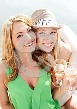 Smiling girls with champagne glasses