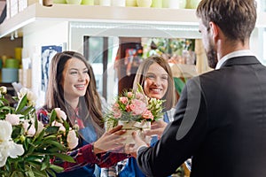 Smiling girls giving a bouquet