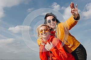 smiling girls piggybacking and waving in Saint michaels mount