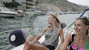 Smiling girls riding on the motor boat