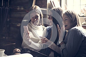 Smiling girls using smart phone.