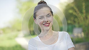 Smiling glorious female in summer park