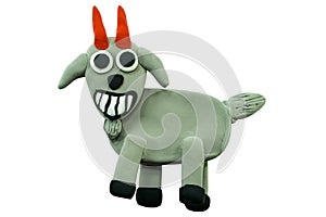 Smiling goat made from plasticine on white